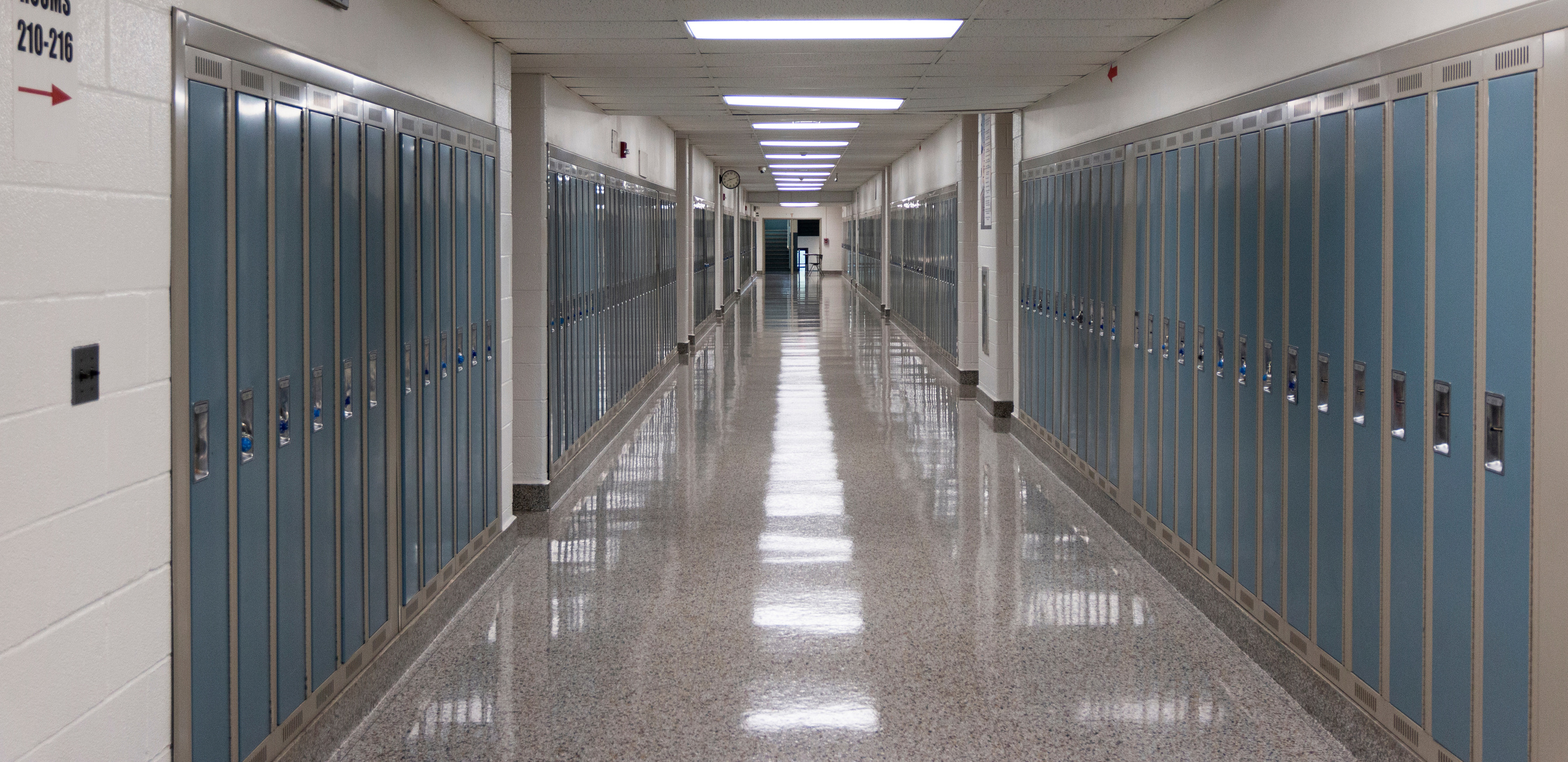 American high school hallway lined with lockers and lights refle